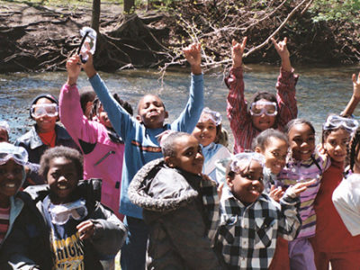 Children with arms raised and happy, at the Rouge River