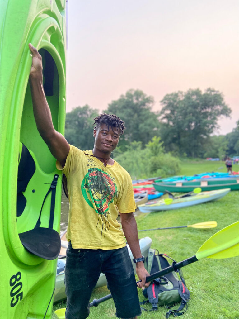Browns & Blacks In Kayaks-2021 young man holding his kayak upright
