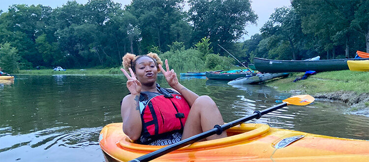 Browns & Blacks In Kayaks-2021 featured image woman giving the double-victory pose