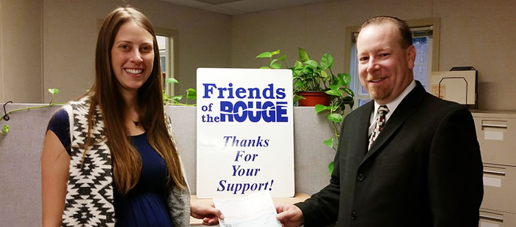 Marie McCormick and Randall S. Ross check presentation photo