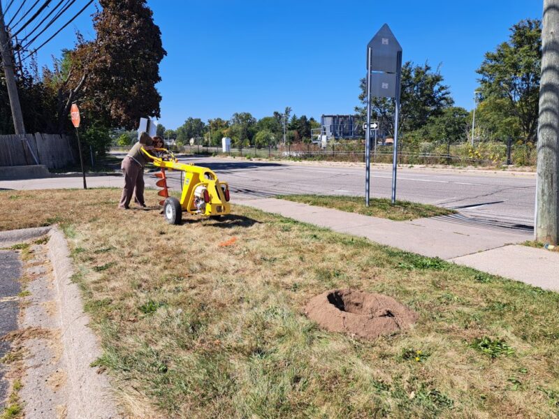 FOTR staff drilling holes for shrub planting at Thurston