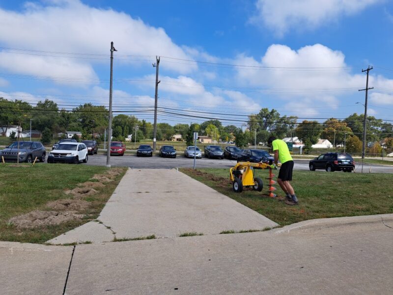 FOTR staff drilling holes for shrub planting at Thurston